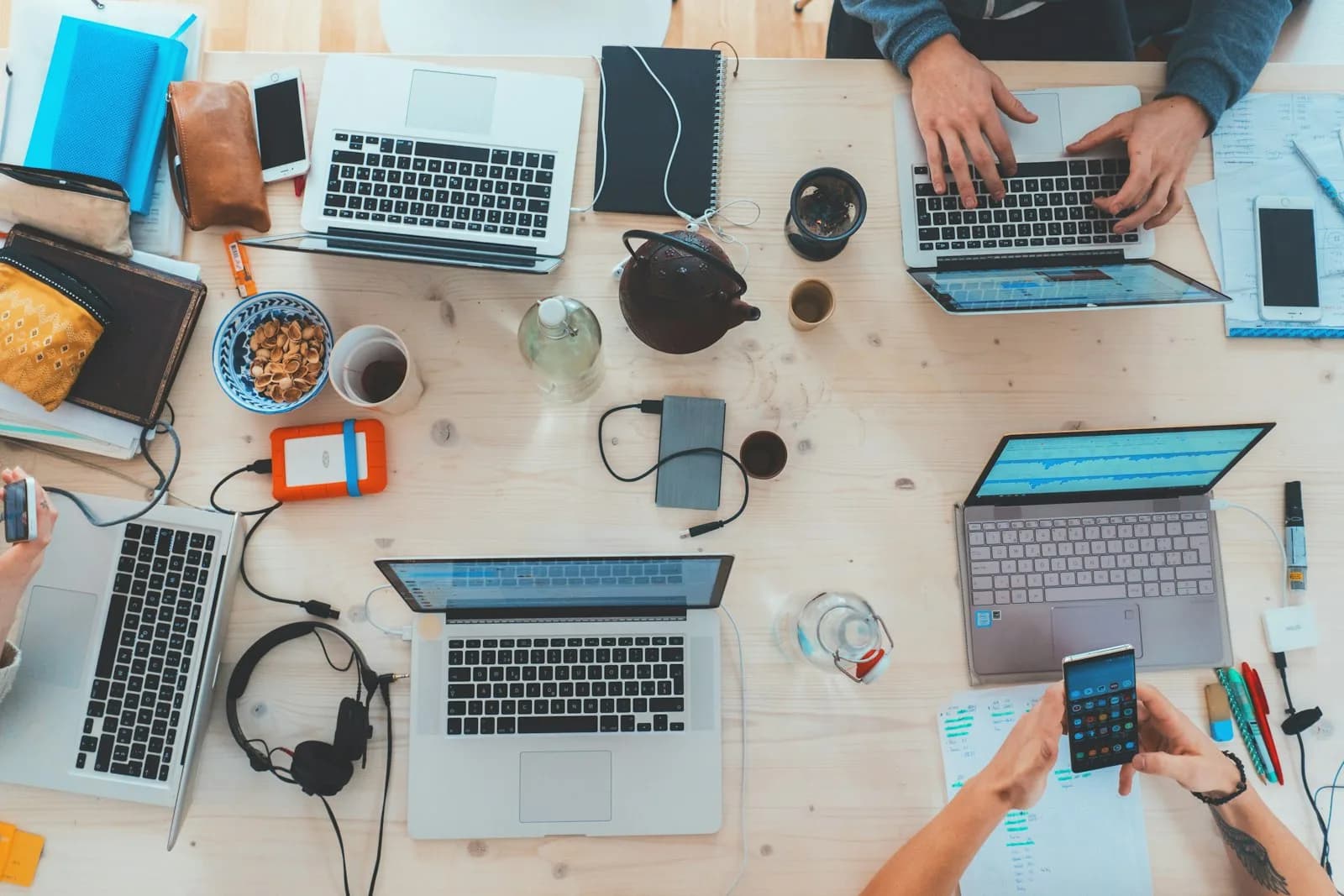 Team working with laptops around a table