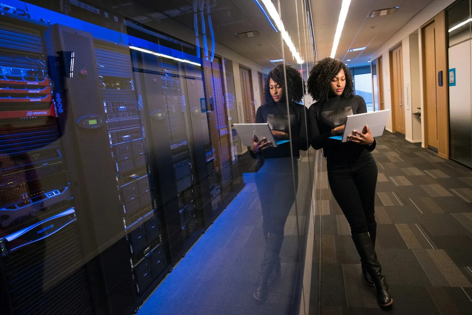 Specialist reviewing information next to a data center