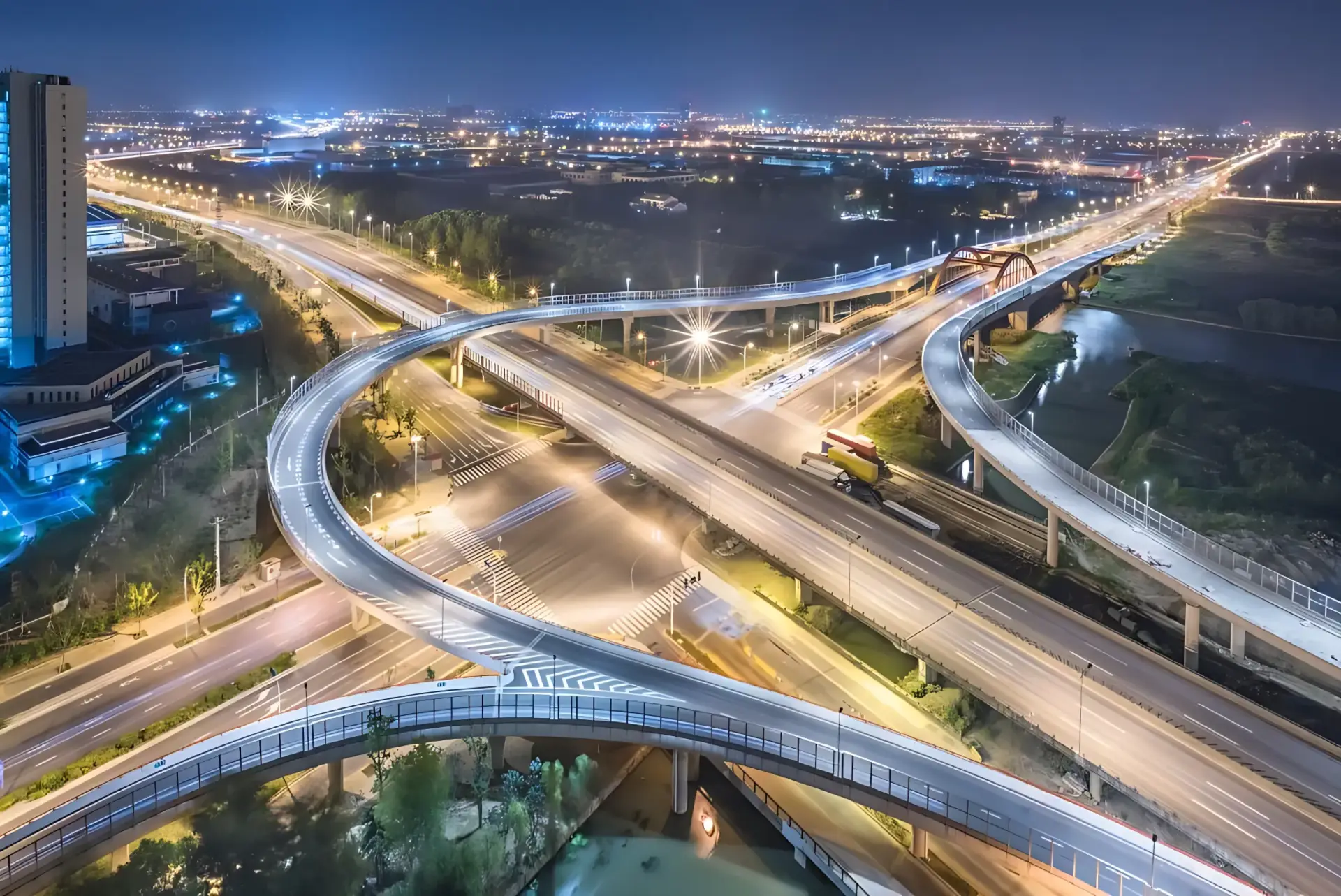 Night road network with illuminated interchanges seen from above